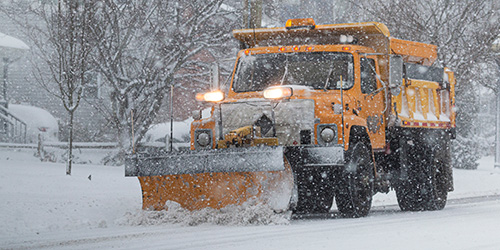 Snow removal truck plowing snow
